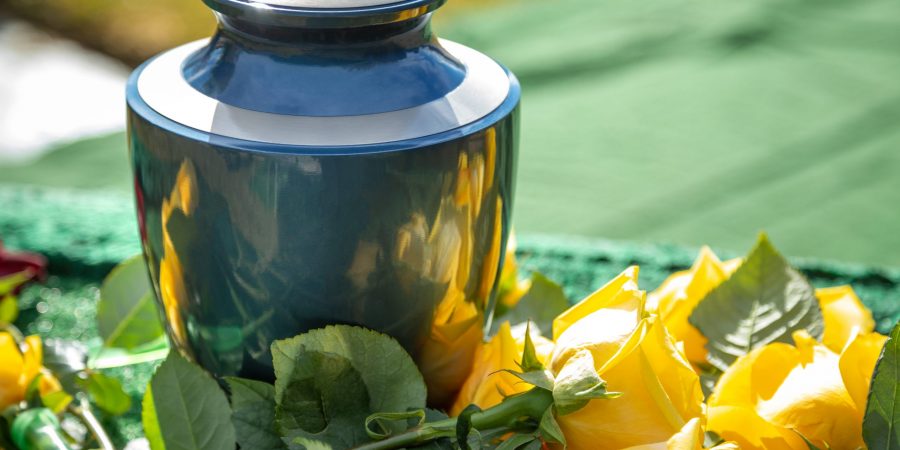 Urn with yellow roses, at an outdoor funeral