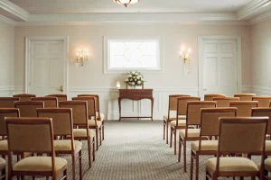 Rows of padded stacking chapel chairs arranged in a professional funeral home chapel