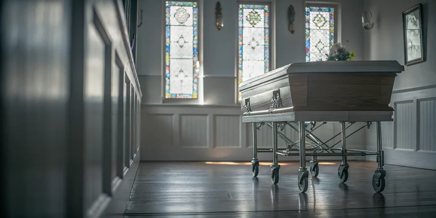 Funeral home chapel interior with a polished church truck on hardwood floor, warm wood tones, soft natural light