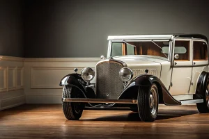 A vintage funeral church truck with a polished metal frame and classic wheels.