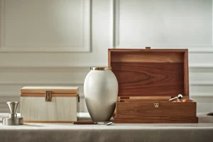 A collection of funeral home supplies including a cremation urn and memorial boxes.